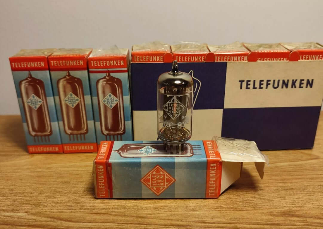 Telefunken radio vacuum tubes with boxes, showcasing vintage audio amplification technology.